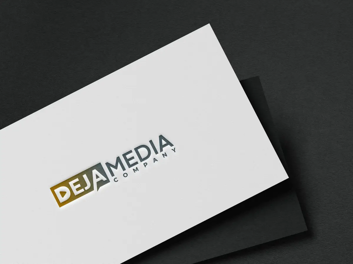 Corporate business cards in gold foil, fanned on a dark surface.